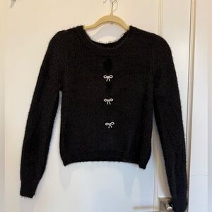 Black peekaboo cutout sweater with bows